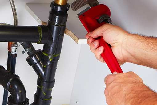 Emergency Plumber Working Under The Sink of Bangor House