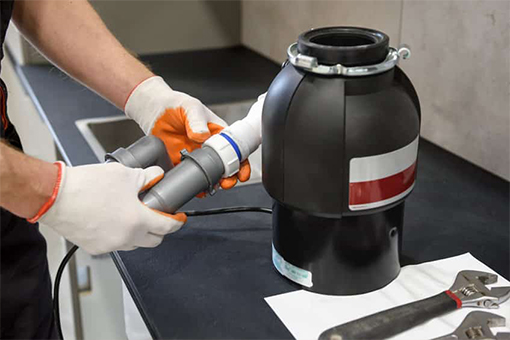 Ongoing Repair of Garbage Disposal in a Bangor House's Kitchen