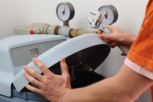 Skilled Plumber Installing Water Softener at a Forks Township Business