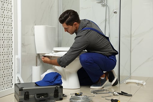 Commercial Plumber Fixing Toilet of a Business in South Whitehall PA