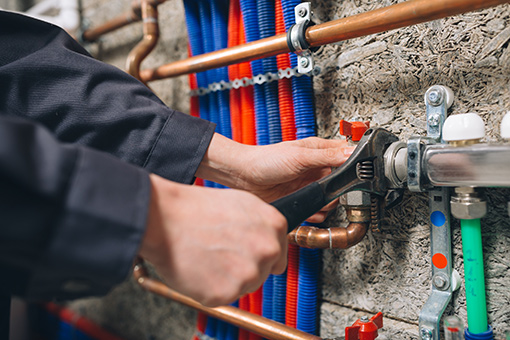 Easton Commercial Plumber Using Wrench To Repair Broken Valve