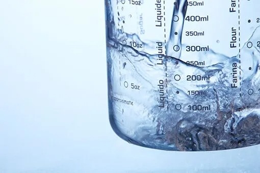 Bethlehem Plumber Testing Water in a Glass in an Allentown Commercial Space