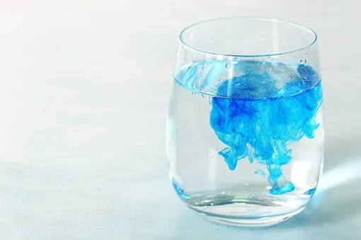 Commercial Water Treatment Bethlehem and Allentown PA Glass of Water with Blue Liquid at an Allentown Commercial Space Before Arrival of Bethlehem Water Treatment Plumbers